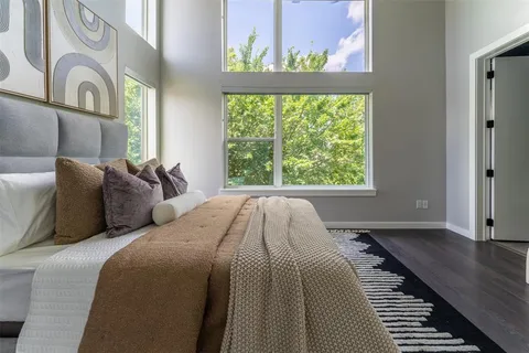 a bed sitting in a bedroom next to a window