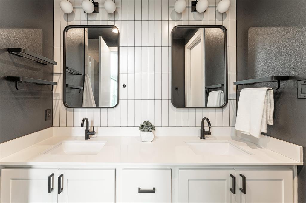 4620 Munger Avenue, Unit 107 Dallas, TX 75204 - Photo 14 of 28 a bathroom with double vanity sinks and a mirror