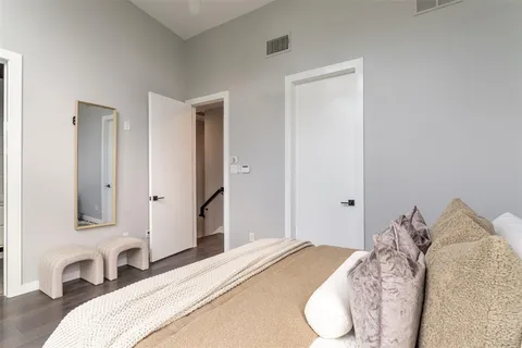 a bedroom with a bed and a lamp