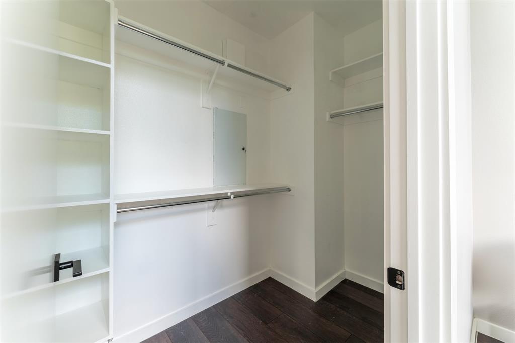 4620 Munger Avenue, Unit 107 Dallas, TX 75204 - Photo 17 of 28 a view of an empty walk in closet with wooden floor