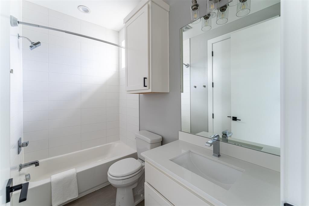 4620 Munger Avenue, Unit 107 Dallas, TX 75204 - Photo 20 of 28 a bathroom with a sink a toilet and shower