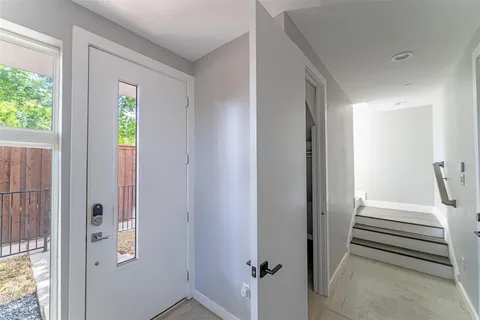 a view of a hallway with wooden floor and entryway