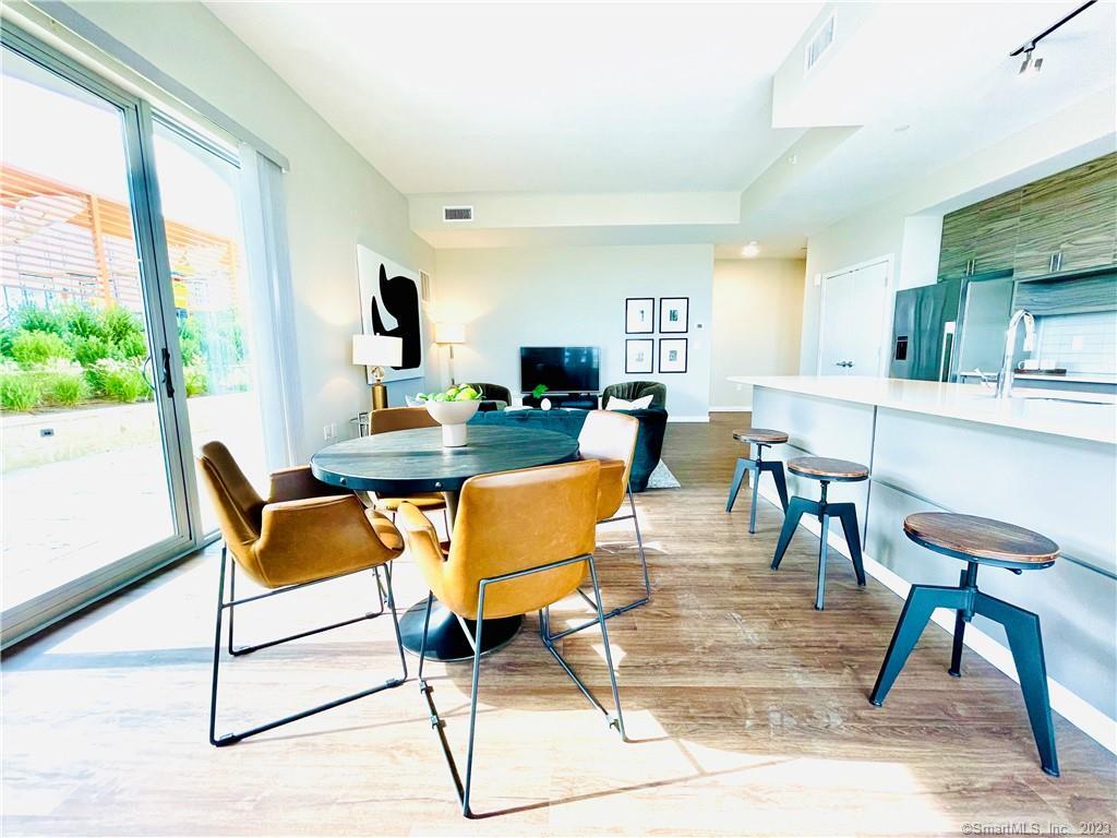 900 Pacific Street, Unit 322 Stamford, CT 06902 - Photo 2 of 8 a view of a dining room with furniture window and outside view