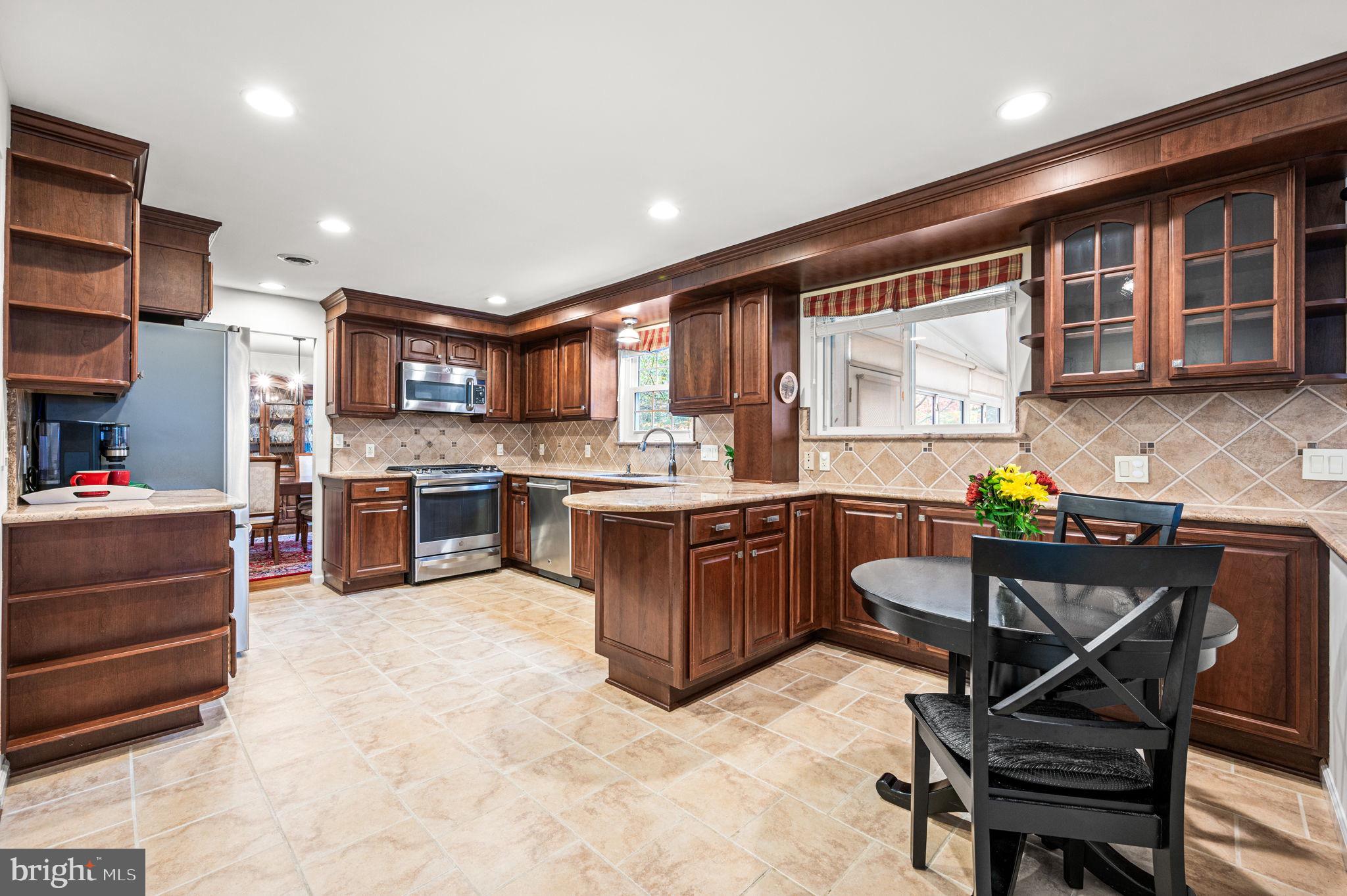 509 Lawrence Drive Springfield, PA 19064 - Photo 13 of 37 a kitchen with a refrigerator and a stove top oven