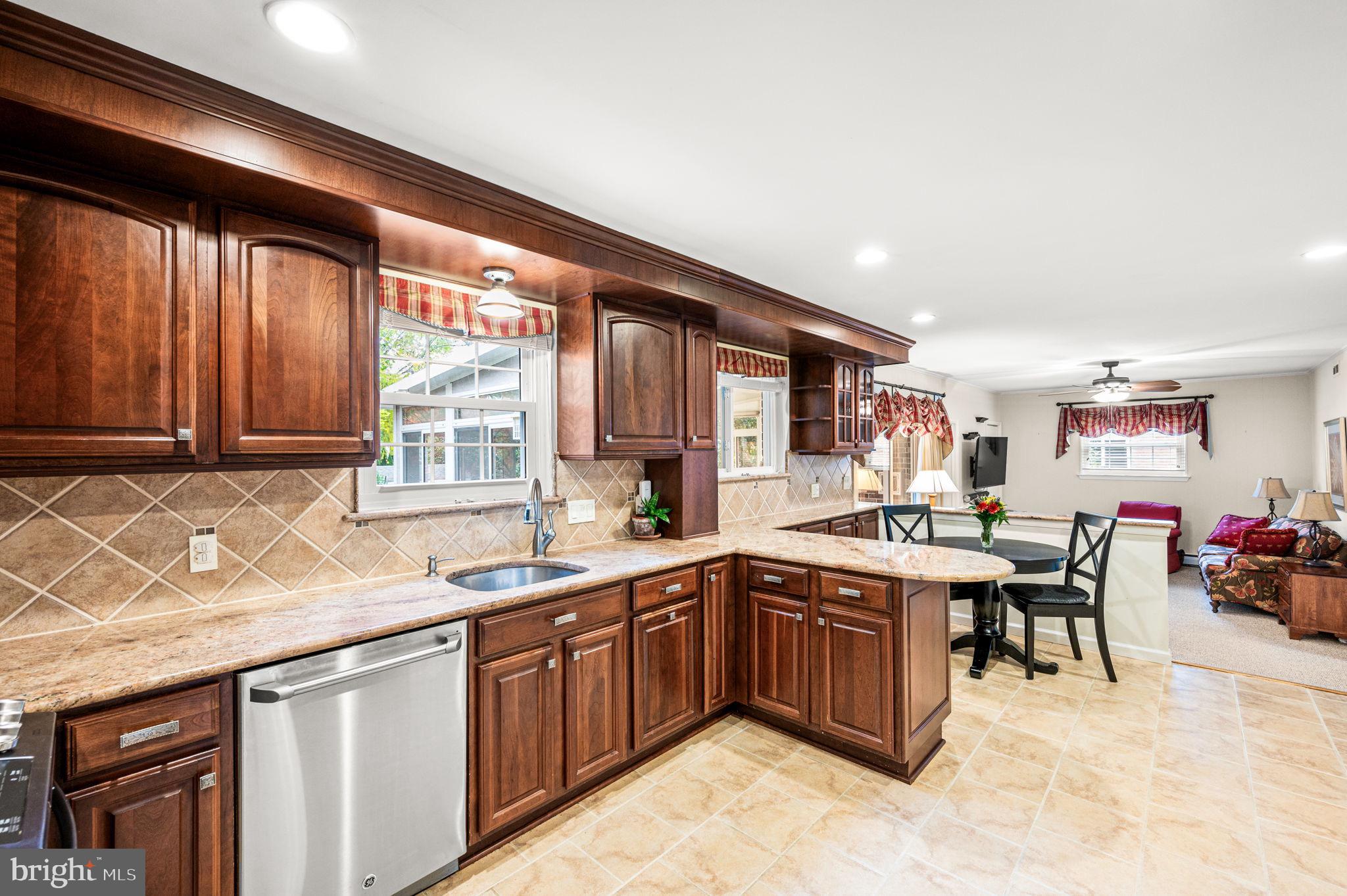 509 Lawrence Drive Springfield, PA 19064 - Photo 14 of 37 a kitchen with lots of counter top space and living room
