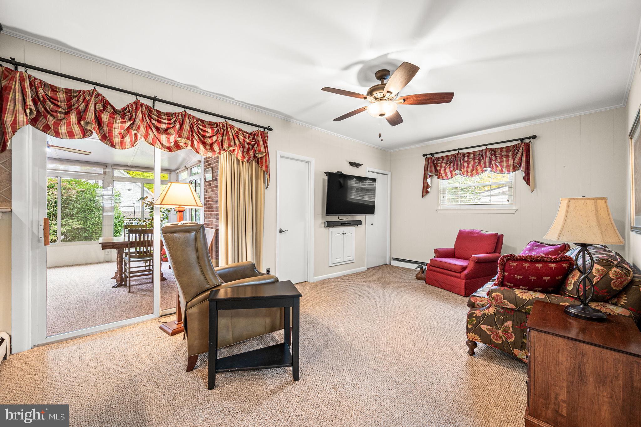 509 Lawrence Drive Springfield, PA 19064 - Photo 16 of 37 a living room with furniture a flat screen tv and a large window
