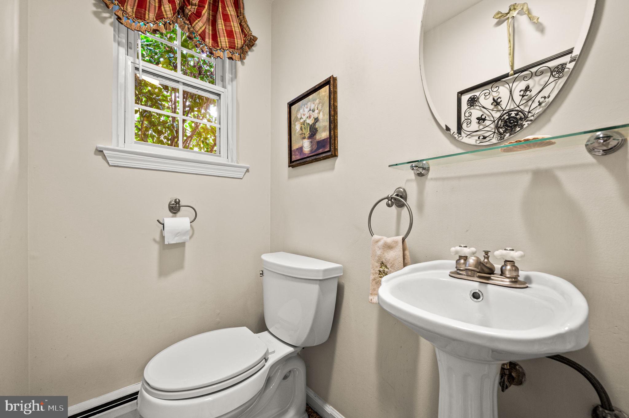 509 Lawrence Drive Springfield, PA 19064 - Photo 20 of 37 a bathroom with a toilet a sink and a window