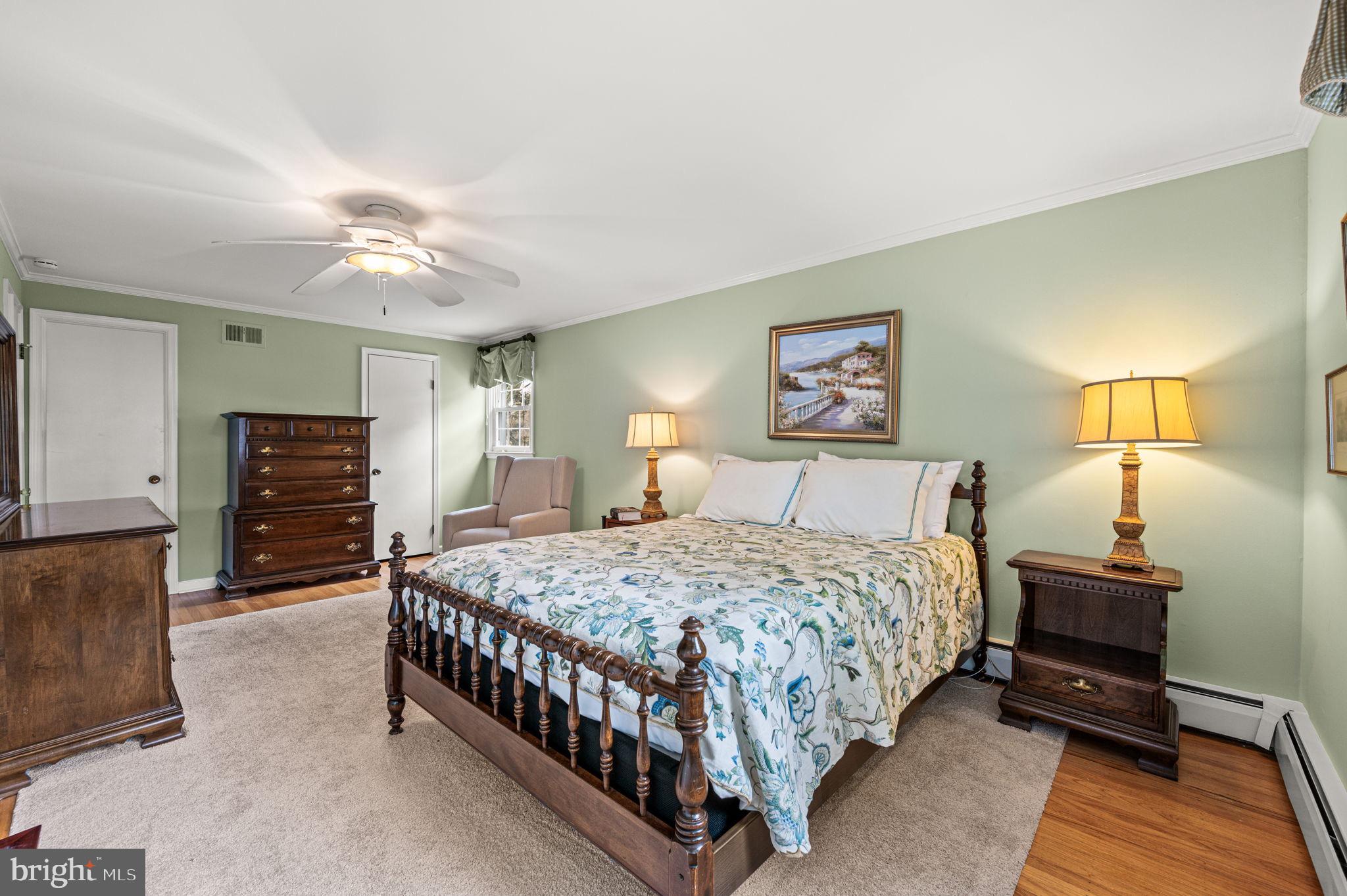 509 Lawrence Drive Springfield, PA 19064 - Photo 22 of 37 a bedroom with a bed chandelier and a window