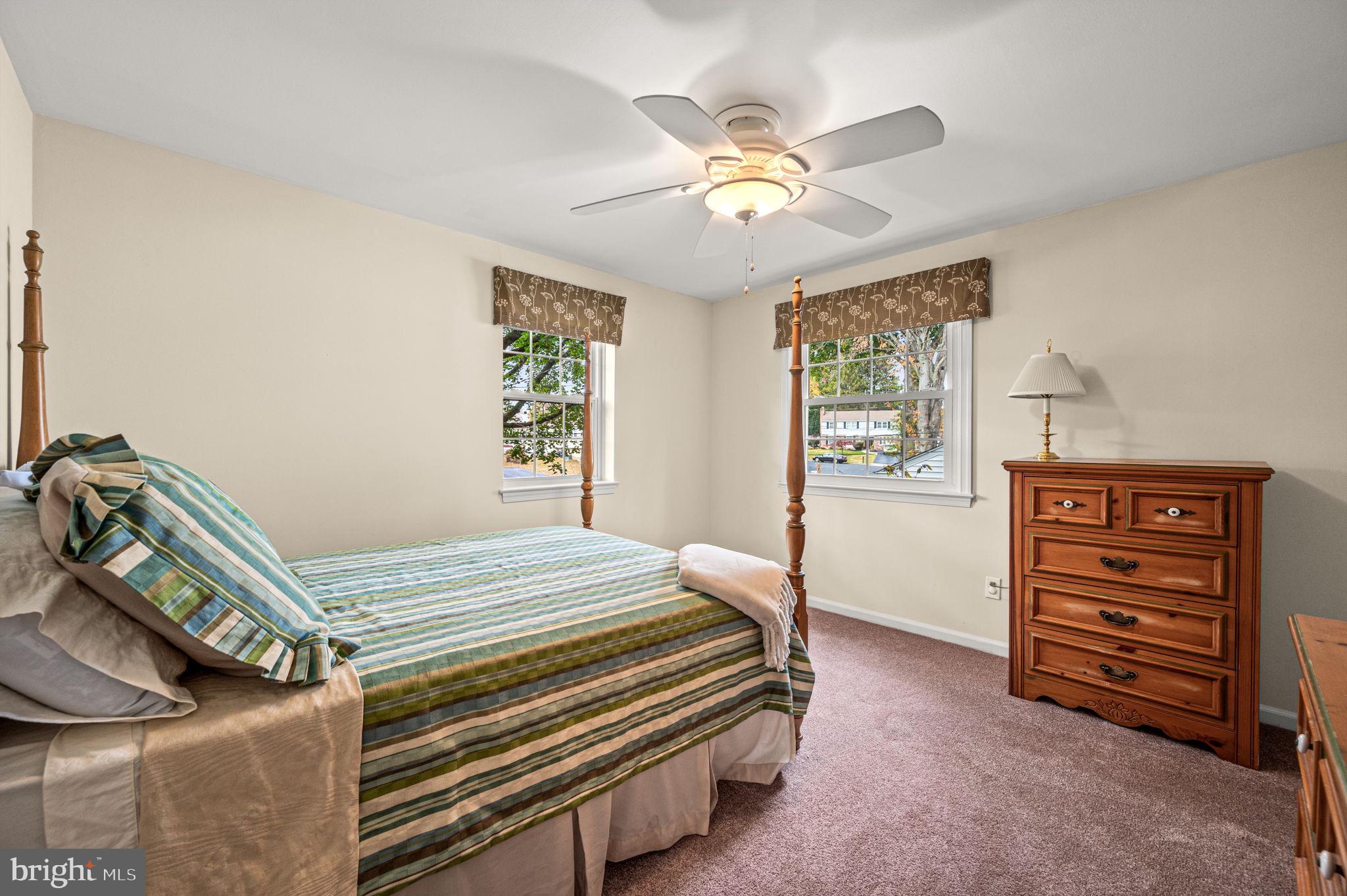 509 Lawrence Drive Springfield, PA 19064 - Photo 25 of 37 a bedroom with a bed and a chandelier