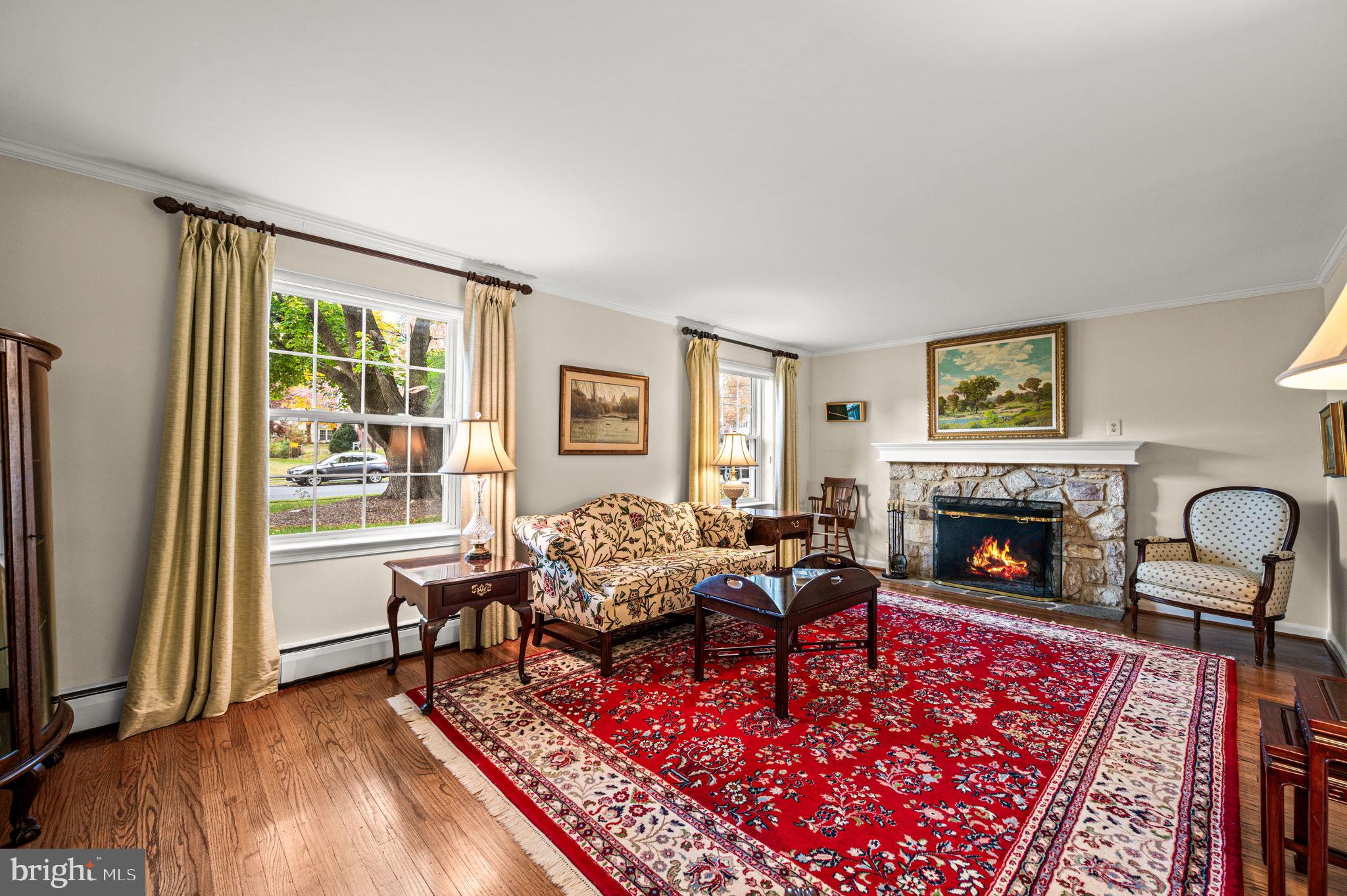 509 Lawrence Drive Springfield, PA 19064 - Photo 8 of 37 a living room with furniture large window and a fireplace