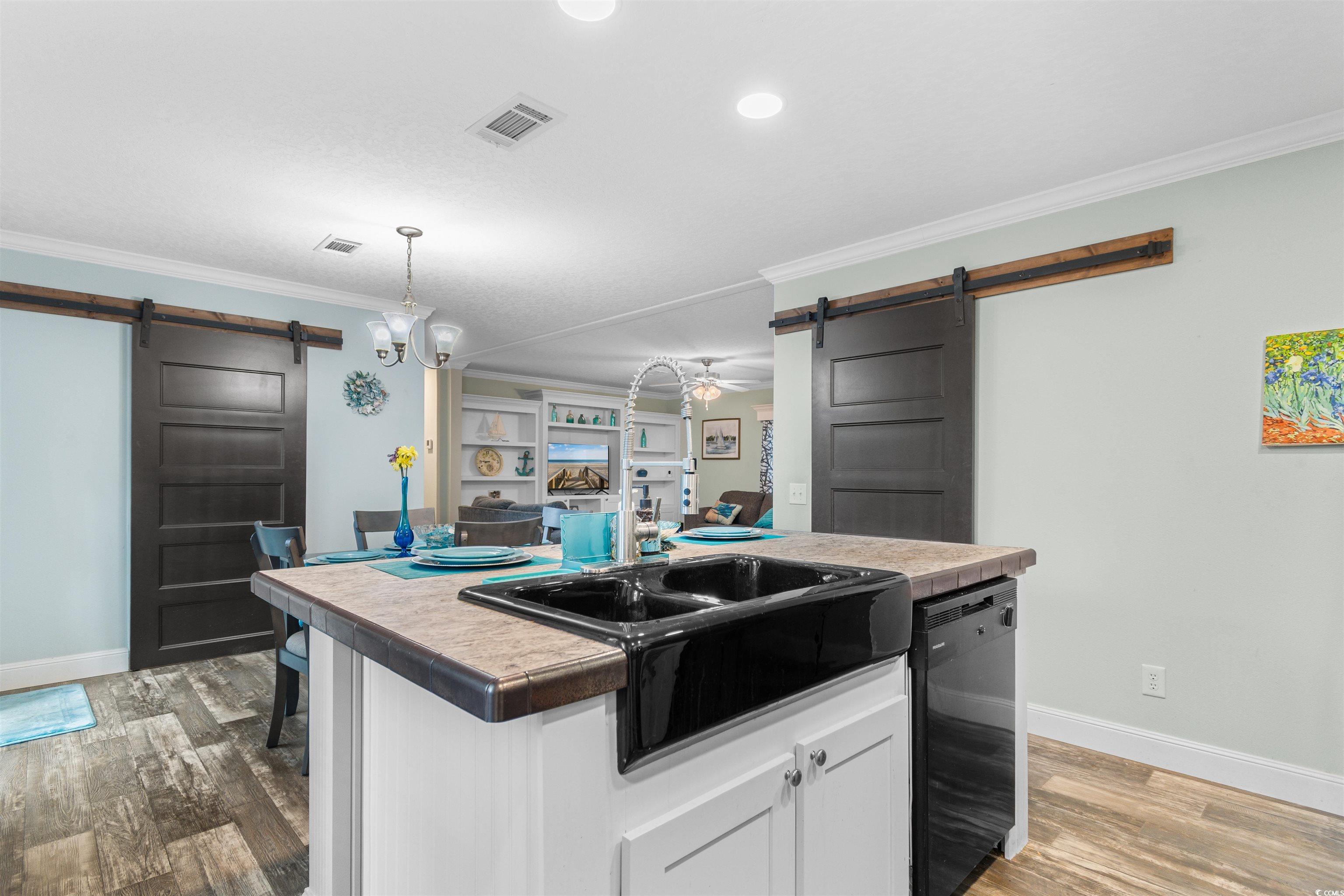 8042 Louisville Road Aynor, SC 29511 - Photo 15 of 34 Kitchen with a barn door, dishwasher, baseboards,