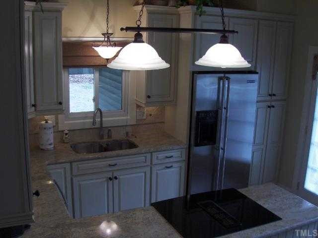 2717 Salisbury Raleigh, NC 27603 - Photo 3 of 12 a kitchen with stainless steel appliances granite countertop a sink a stove and a refrigerator