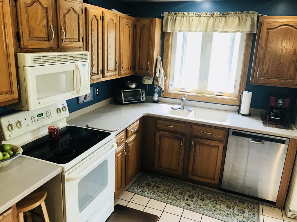104 Fitzgerald Road Charlton, MA 01507 - Photo 5 of 14 a kitchen with stainless steel appliances a sink stove and cabinets