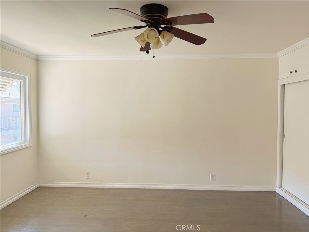 2030 East 3rd Street, Unit 5 Long Beach, CA 90814 - Photo 20 of 23 an empty room with a window and a ceiling fan