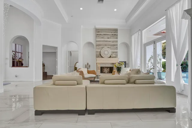 a living room with furniture gym equipment and a chandelier