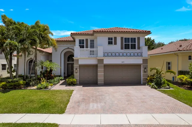 a front view of a house with a garden and plants