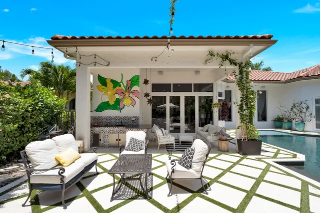 a view of a patio with table and chairs and potted plants