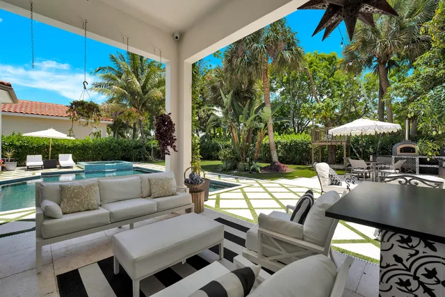 a outdoor kitchen with a large window and dining table