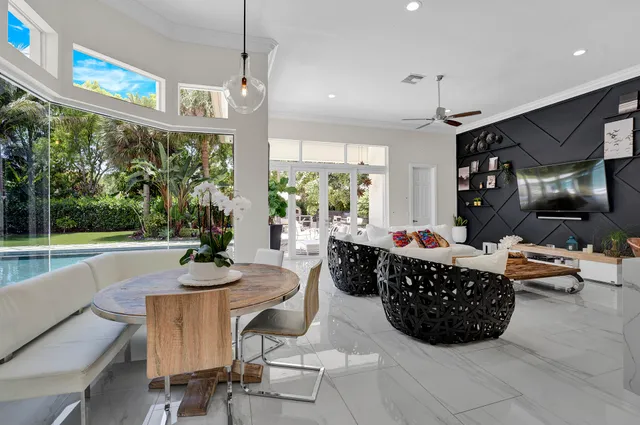 a living room with furniture and floor to ceiling windows