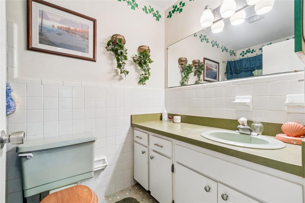2059 Waterfall Drive Spring Hill, FL 34608 - Photo 18 of 26 a bathroom with a sink a vanity and a mirror