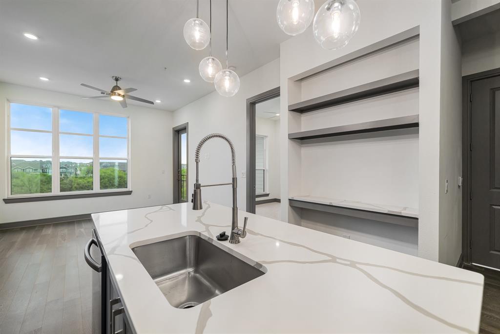2700 Old Denton Road, Unit 3336 Carrollton, TX 75007 - Photo 1 of 29 a kitchen with a sink and a large mirror