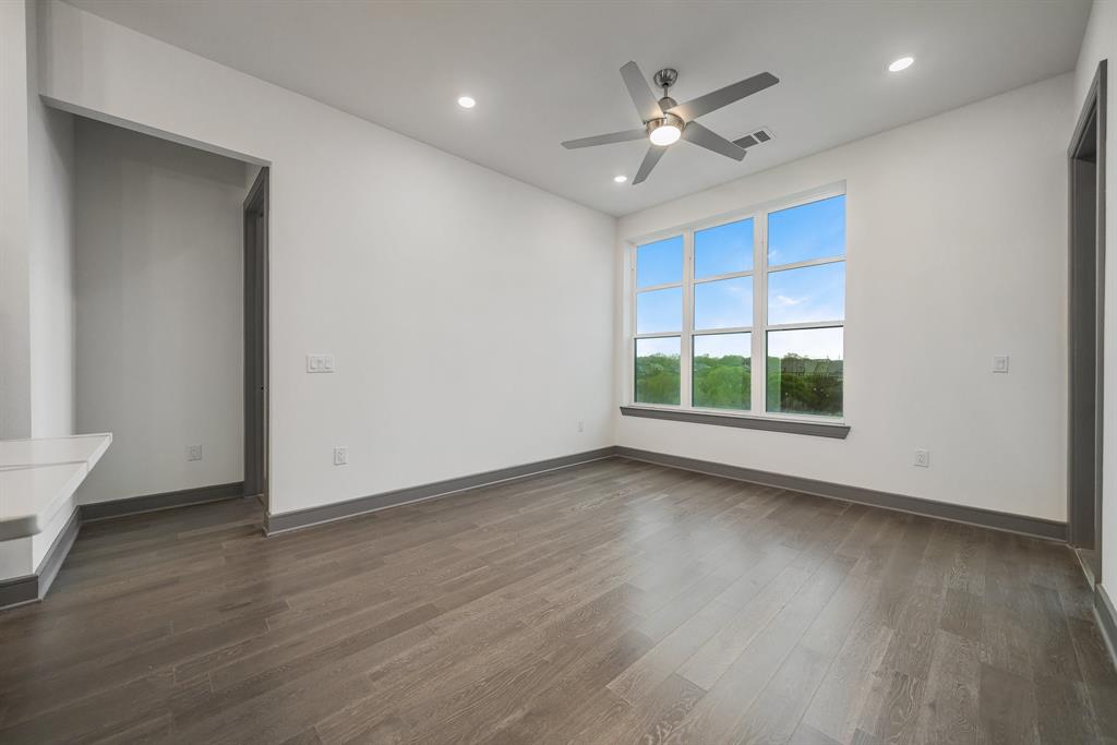 2700 Old Denton Road, Unit 3336 Carrollton, TX 75007 - Photo 2 of 29 a view of an empty room with wooden floor and a window