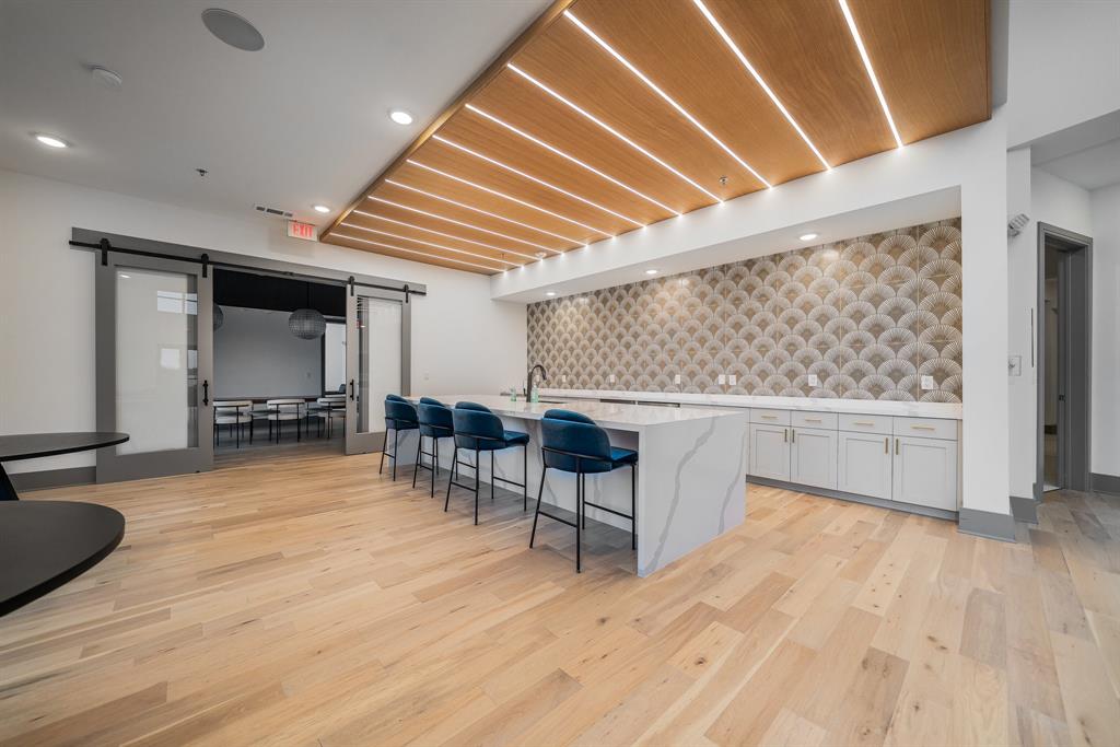 2700 Old Denton Road, Unit 3336 Carrollton, TX 75007 - Photo 27 of 29 a view of a room with chairs and wooden floor