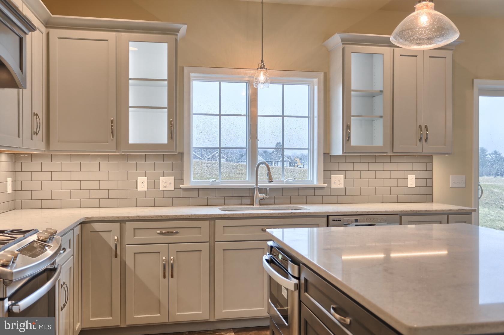23 Rolling Meadow Road Lebanon, PA 17046 - Photo 20 of 44 a kitchen with stainless steel appliances granite countertop a sink a stove and a granite counter tops with white cabinets