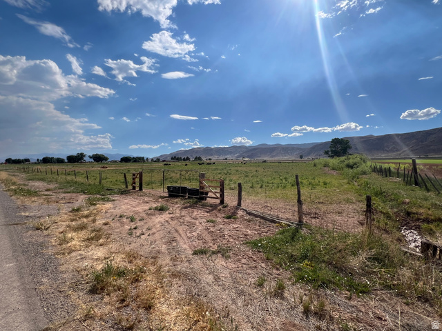 950 West Old Airport Road Monroe, UT 84754 - Photo 4 of 5 Expansive land parcel featuring existing fencing, a rustic wooden gate, and a wide-open field