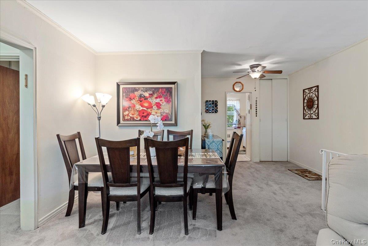 87-44 Marengo Street, Unit 2A Queens, NY 11423 - Photo 13 of 23 a dining room with furniture and chandelier