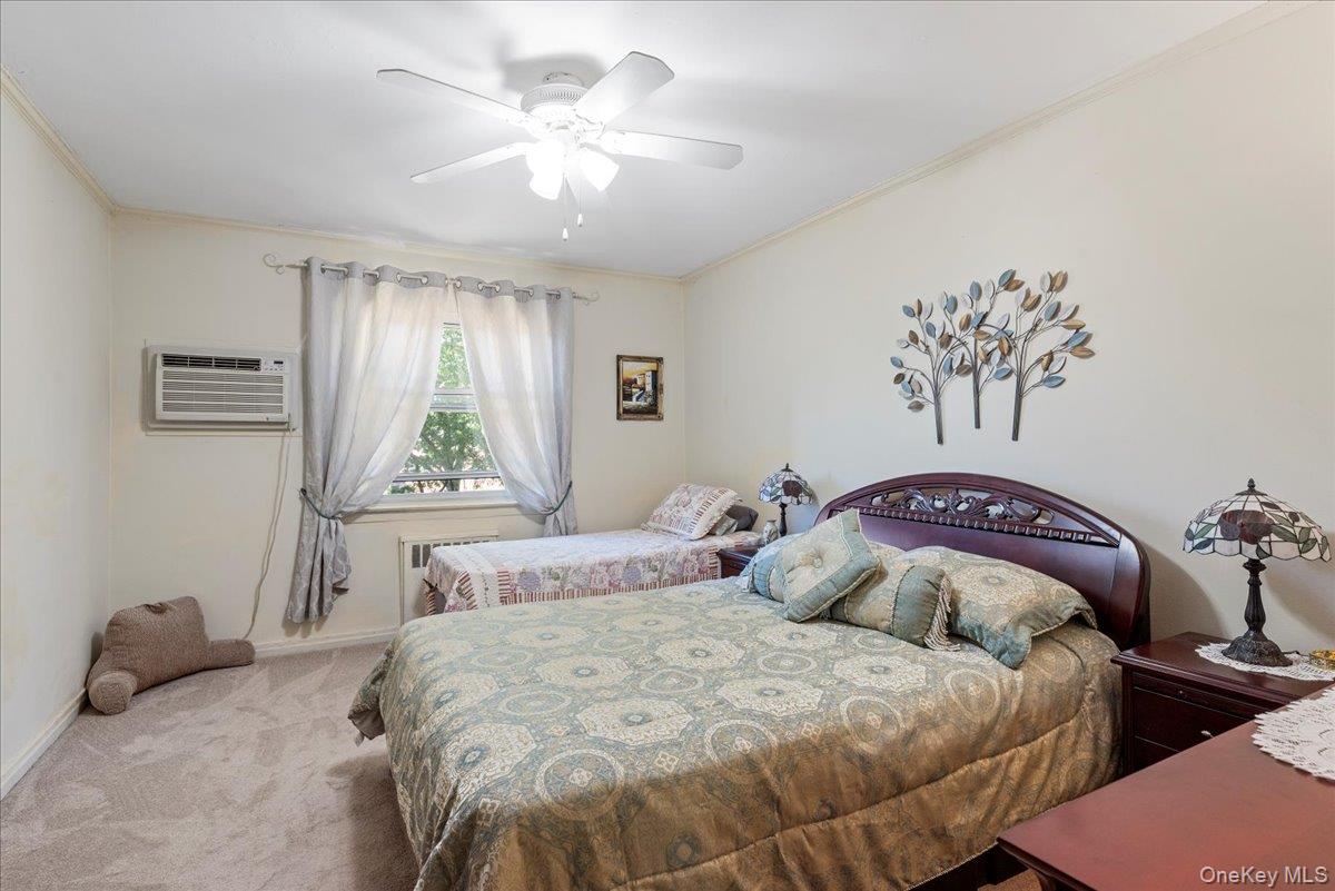 87-44 Marengo Street, Unit 2A Queens, NY 11423 - Photo 14 of 23 a bedroom with a bed and a chandelier