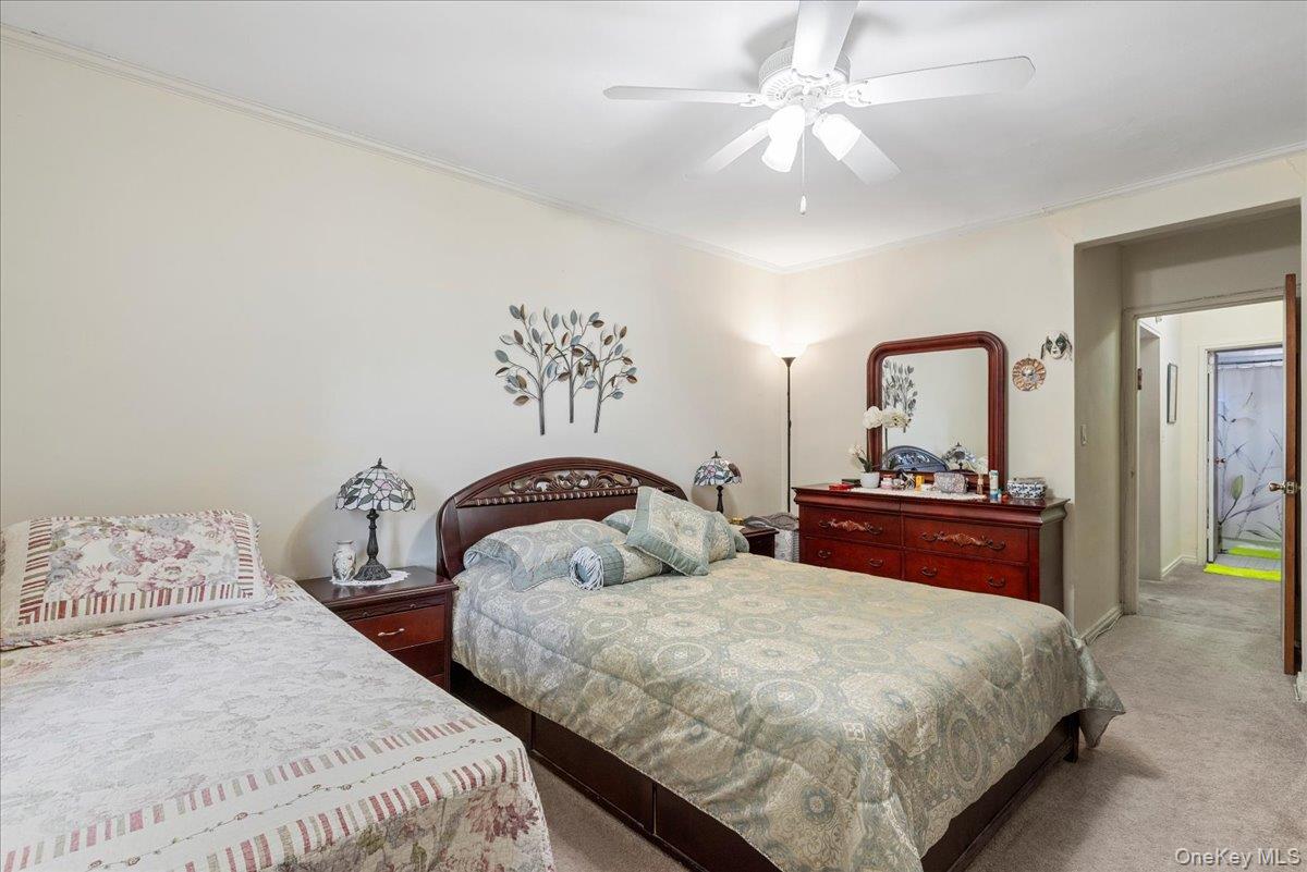 87-44 Marengo Street, Unit 2A Queens, NY 11423 - Photo 15 of 23 a bedroom with two beds and a chandelier