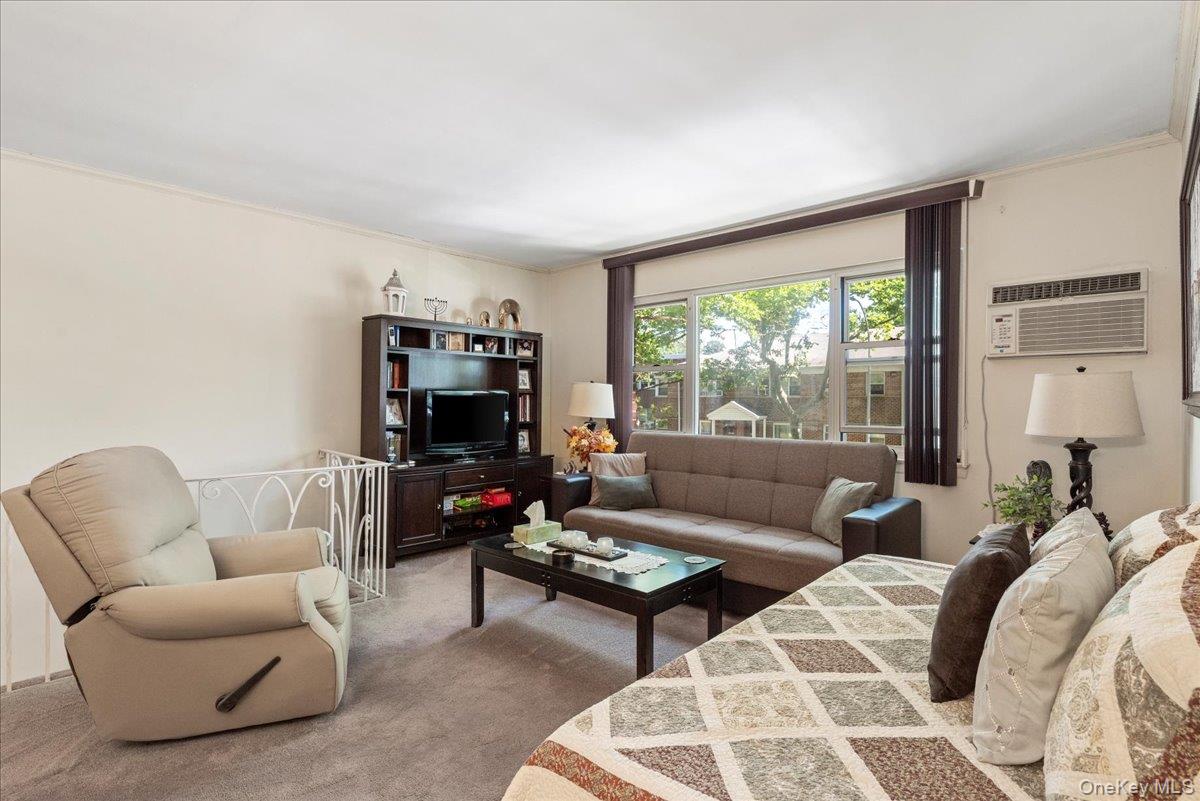 87-44 Marengo Street, Unit 2A Queens, NY 11423 - Photo 7 of 23 a living room with furniture and a large window
