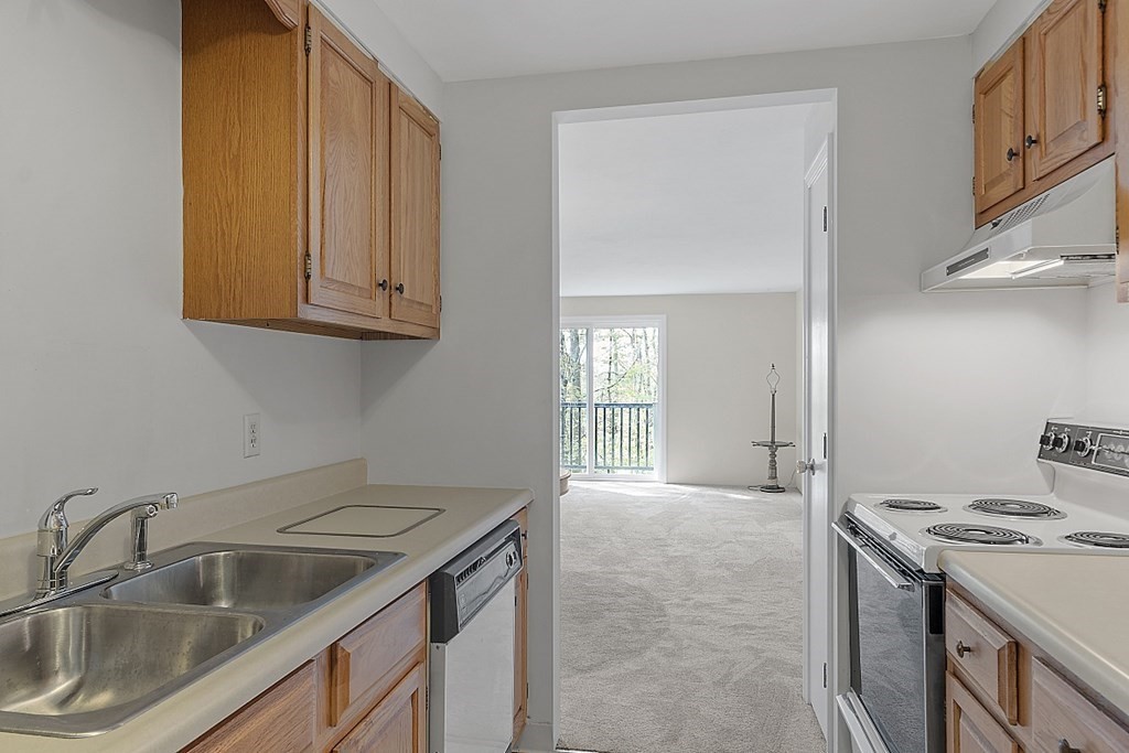 27 Ernest Avenue, Unit 24 Exeter, NH 03833 - Photo 12 of 38 a kitchen that has a sink and a stove