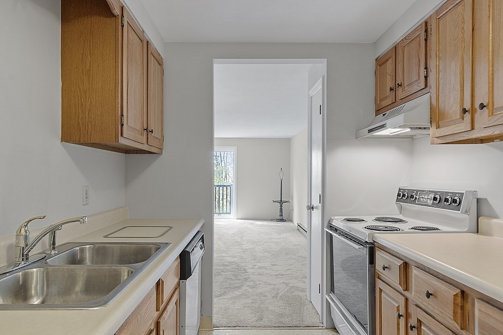 27 Ernest Avenue, Unit 24 Exeter, NH 03833 - Photo 13 of 38 a kitchen with stainless steel appliances granite countertop a sink and cabinets