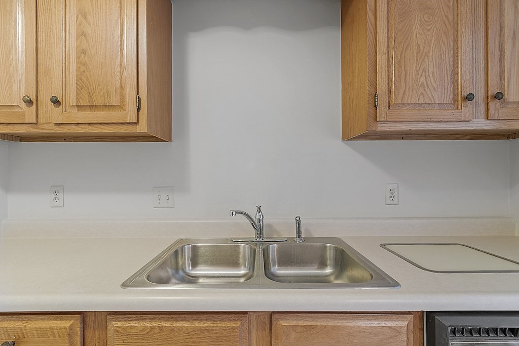 27 Ernest Avenue, Unit 24 Exeter, NH 03833 - Photo 14 of 38 a kitchen with sink and cabinets
