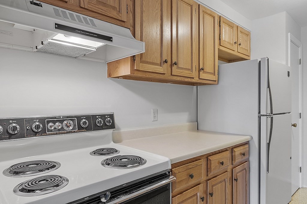27 Ernest Avenue, Unit 24 Exeter, NH 03833 - Photo 15 of 38 a kitchen with a refrigerator and a stove