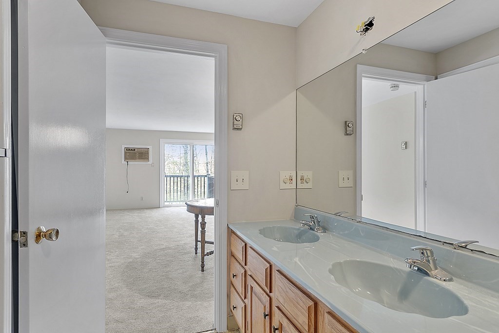 27 Ernest Avenue, Unit 24 Exeter, NH 03833 - Photo 17 of 38 a bathroom with a sink and a mirror