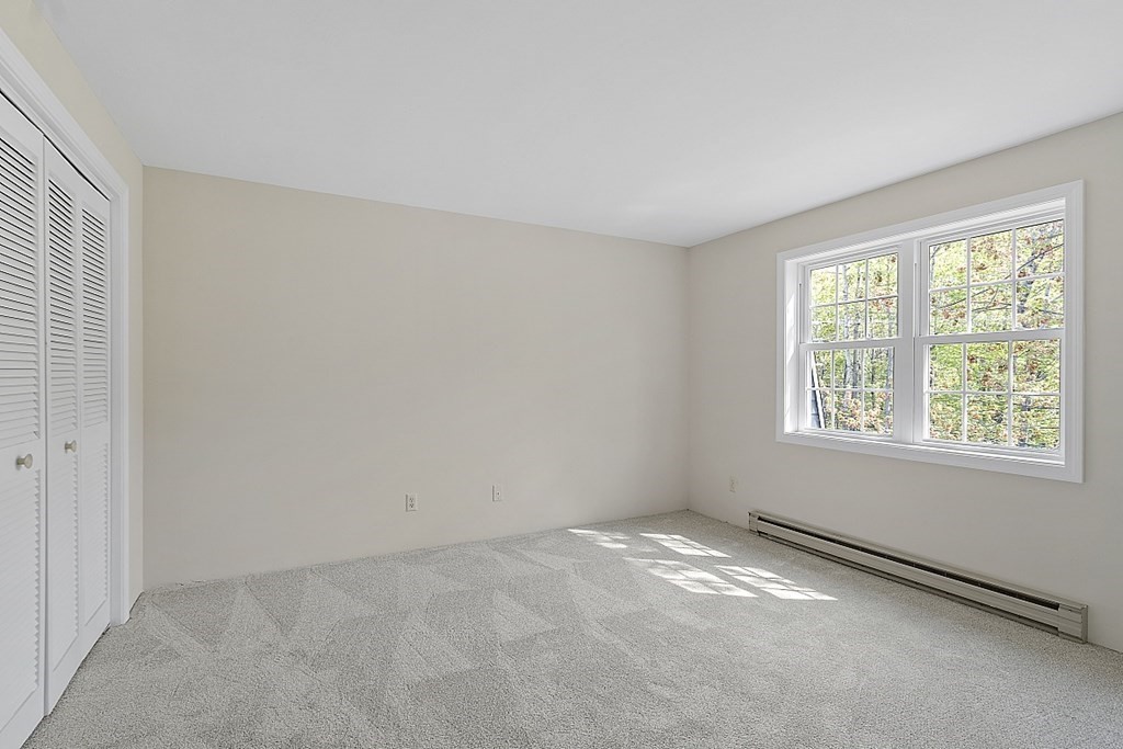 27 Ernest Avenue, Unit 24 Exeter, NH 03833 - Photo 21 of 38 an empty room with a empty space and windows