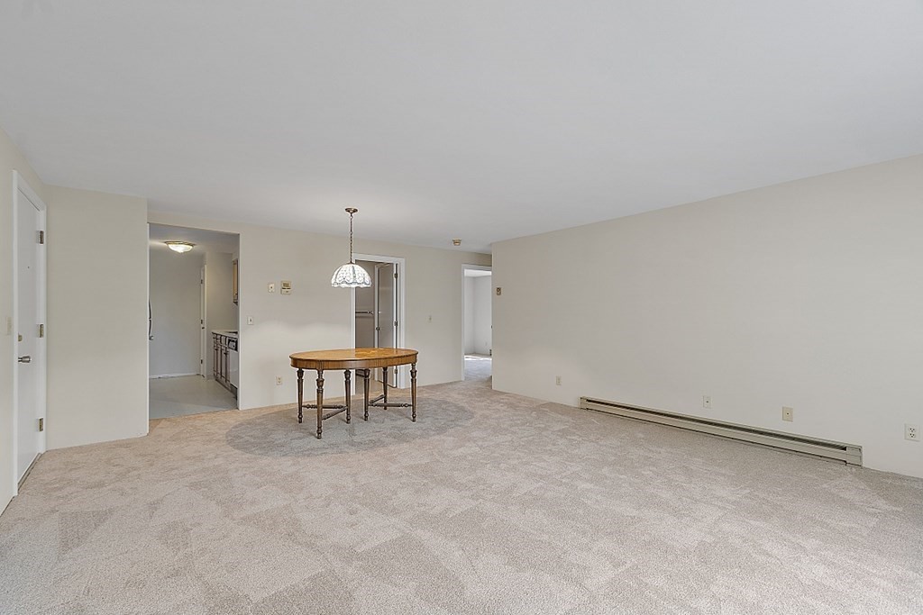 27 Ernest Avenue, Unit 24 Exeter, NH 03833 - Photo 3 of 38 a view of a livingroom with a table and chairs
