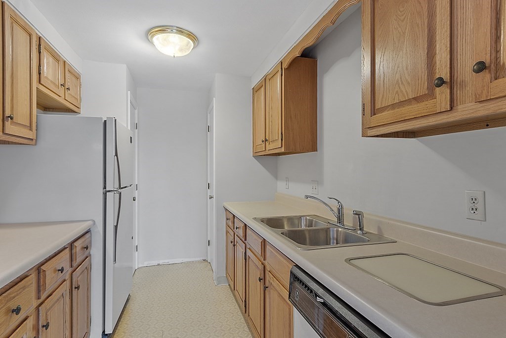 27 Ernest Avenue, Unit 24 Exeter, NH 03833 - Photo 10 of 38 a kitchen with stainless steel appliances granite countertop a sink and a refrigerator