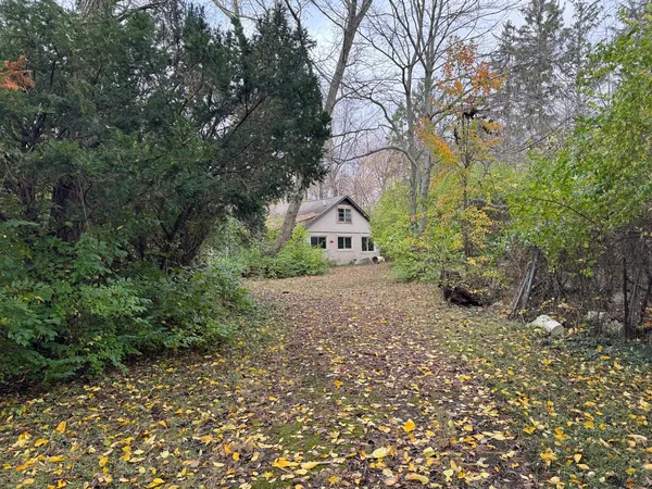 a view of a house with a yard and tree