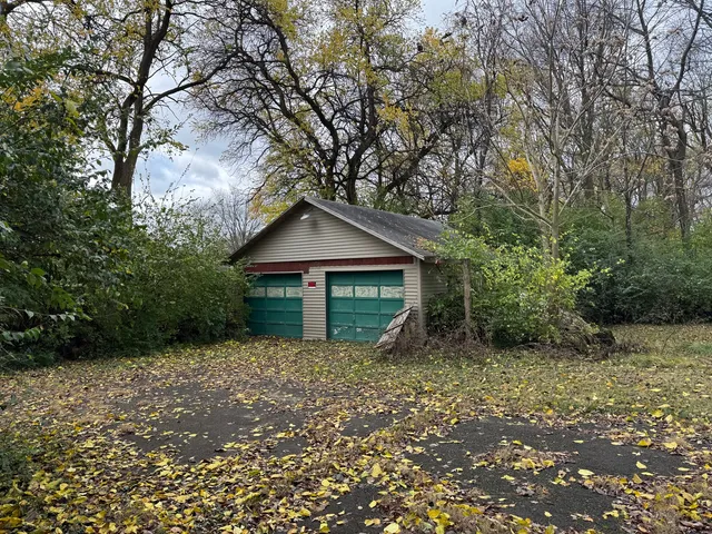 a small house with trees in the background