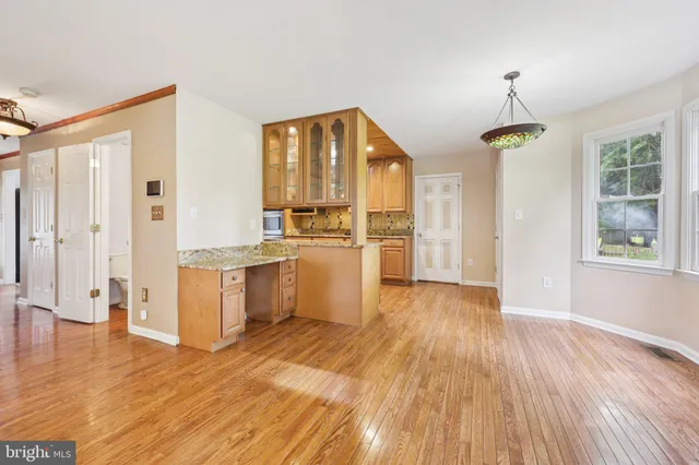 a kitchen with stainless steel appliances granite countertop a sink and wooden cabinets