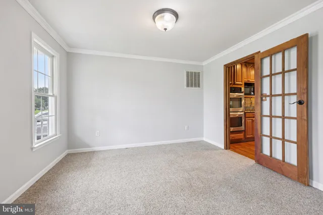 a view of a kitchen with wooden floor and a refrigerator