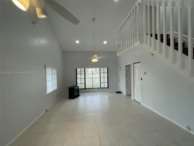 a living room with furniture and a ceiling fan
