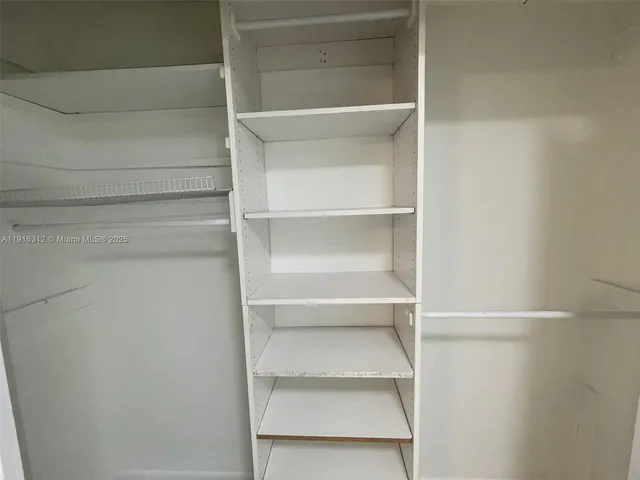 a view of a house with a small yard and wooden fence