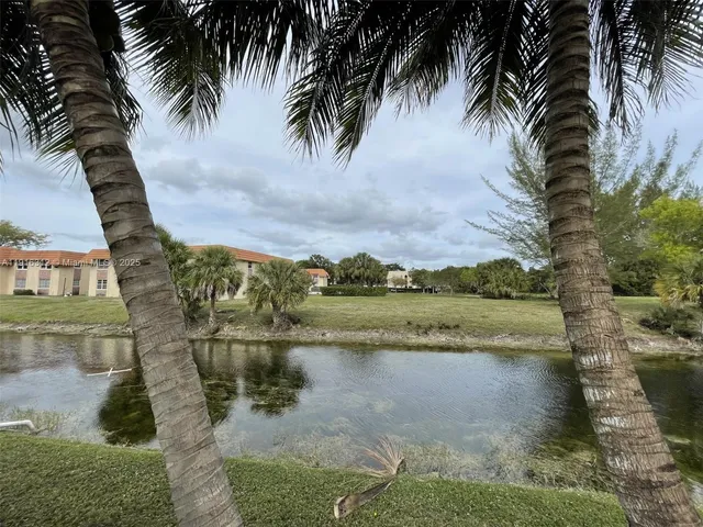 a view of outdoor space with swimming pool and trees in the background
