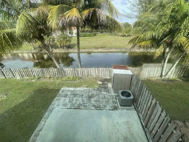 a kitchen with granite countertop a refrigerator and a sink
