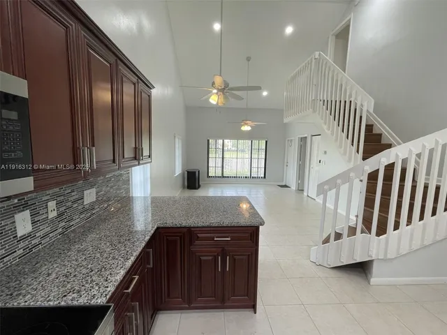 en empty room with windows and fan